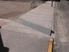 Link to photo - parking lot drain goes under the sidewalk.