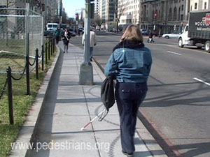 Blind pedestrian and streetlight pole