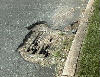Photo - hazardous in-street strom drain.